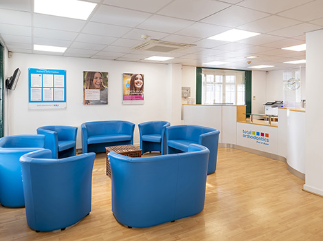 The patient waiting area at Total Orthodontics Hull has comfy blue sofas