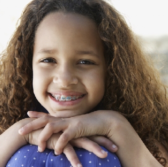 A young girl smiling with braces