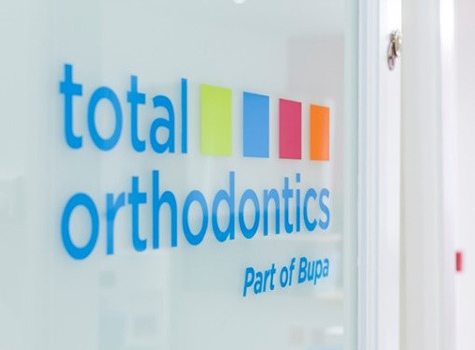 The Total Orthodontics logo on practice signage