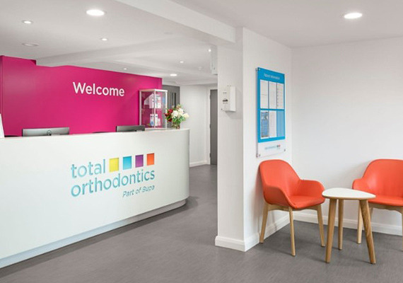 Reception desk and waiting room at a Total Orthodontics practice