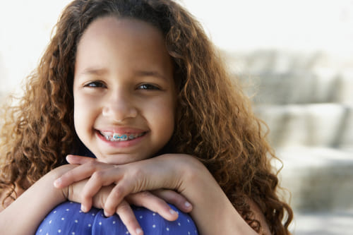 A young girl smiling with braces