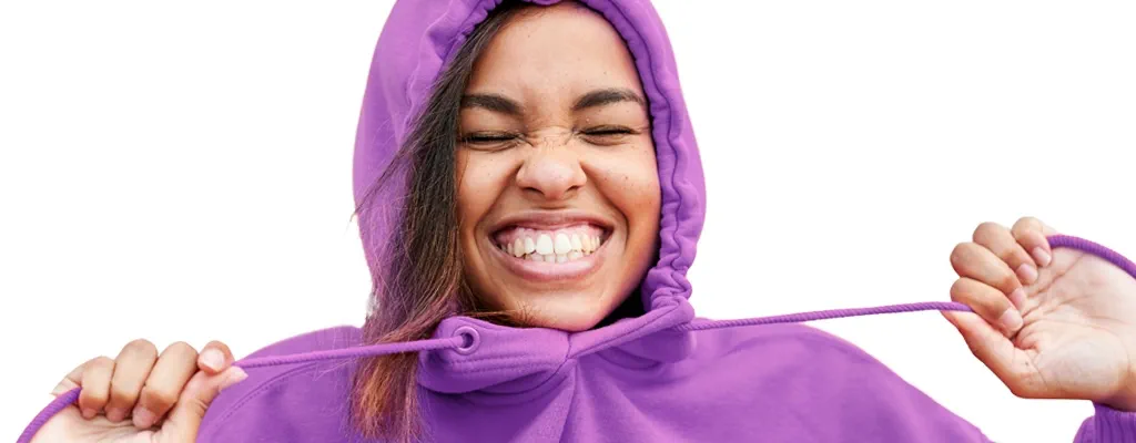 Woman wearing a purple hoodie smiling