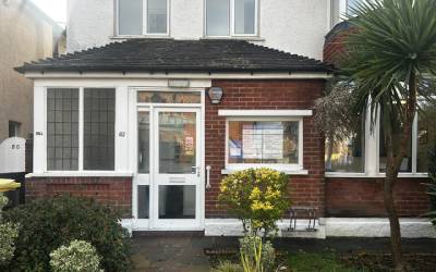 Glass door and red brick front of Total Orthodontics Brighton