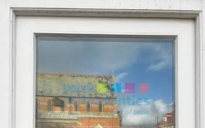 Blue sky reflected in the glass dooor of Total Orthodontics Brighton