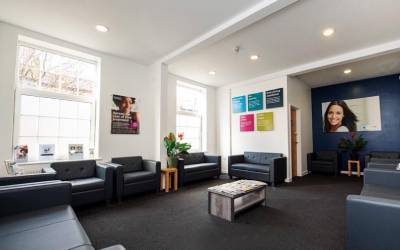 Seating for customers at Total Orthodontics Harrogate with comfy navy blue chairs