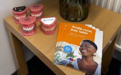 leaflets and typodont model teeth on a table