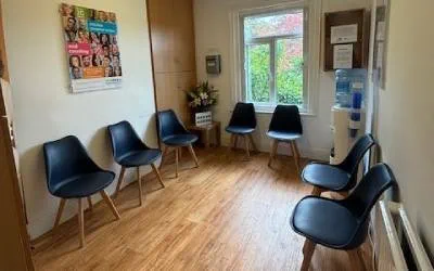 Blue chairs in waiting room with a window